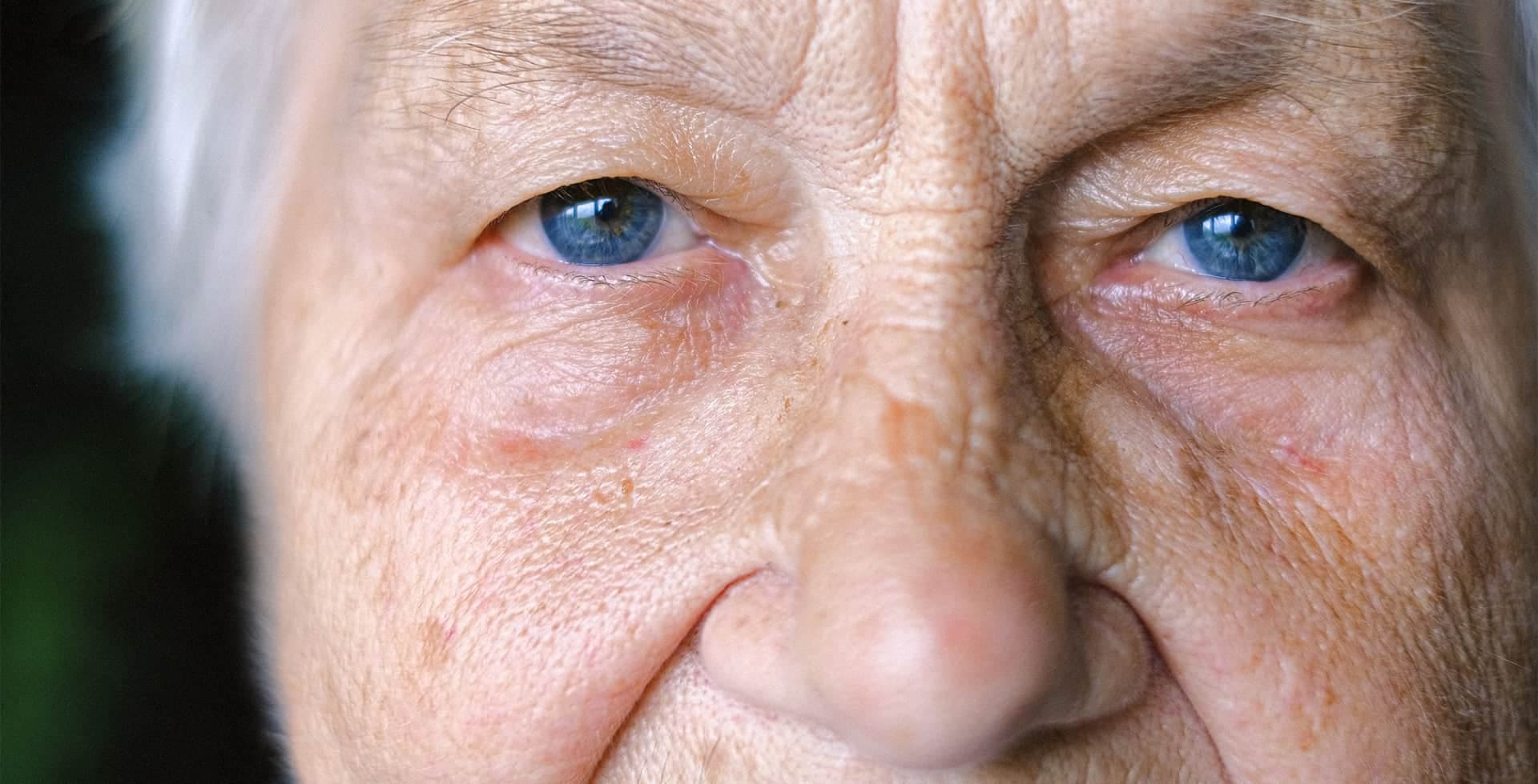 Närbild på en äldre dams ögon som kollar rakt in i kameran.